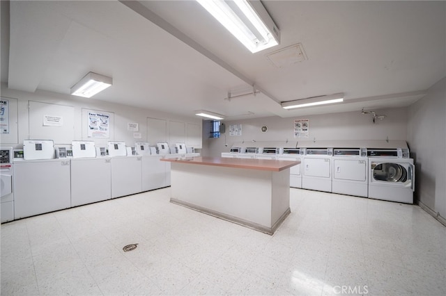 clothes washing area featuring washer and dryer