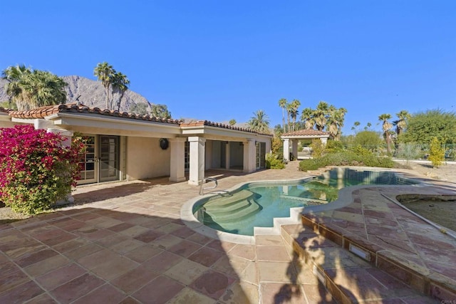 view of pool with a mountain view and a patio area