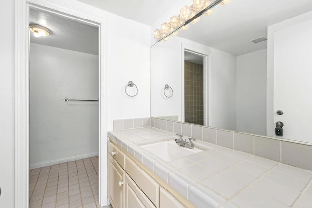 bathroom featuring tile patterned flooring and vanity