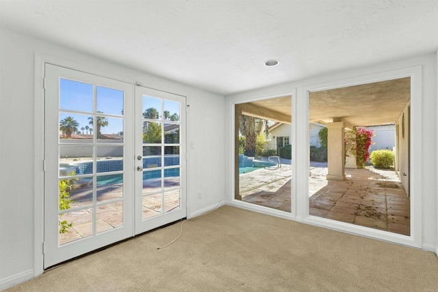 entryway with light colored carpet