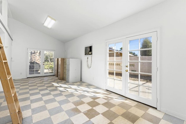 empty room featuring lofted ceiling and french doors