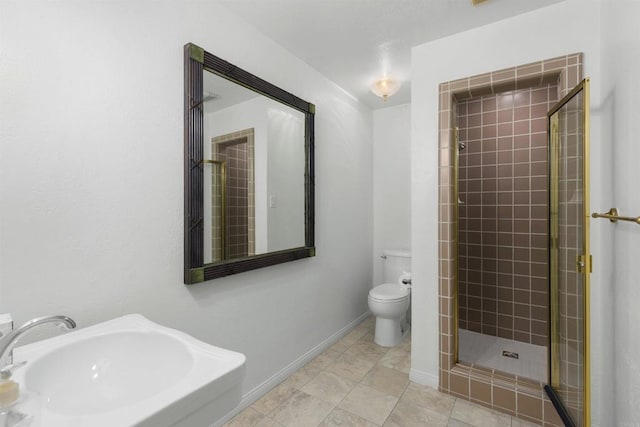 bathroom featuring tile patterned flooring, toilet, an enclosed shower, and sink