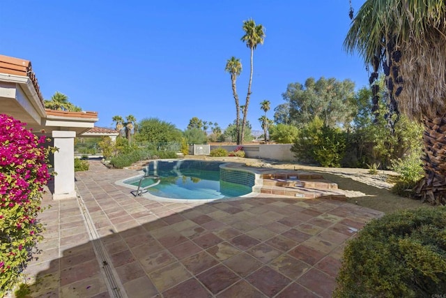 view of swimming pool with a patio and a hot tub