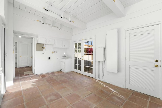 interior space with french doors, track lighting, tile patterned floors, beam ceiling, and wooden ceiling