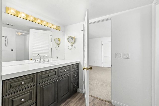 bathroom with vanity and hardwood / wood-style flooring