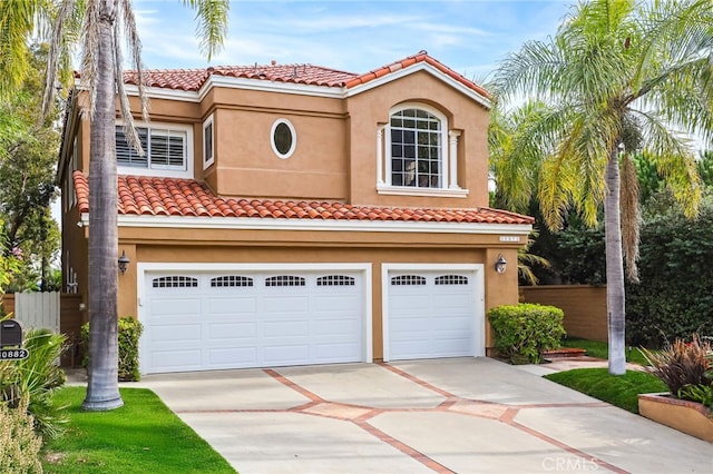 mediterranean / spanish-style house with a garage