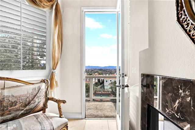 sitting room featuring a mountain view and light tile patterned flooring