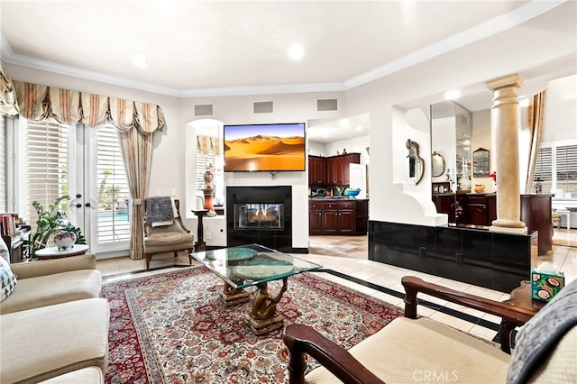 tiled living room with decorative columns, a multi sided fireplace, and crown molding