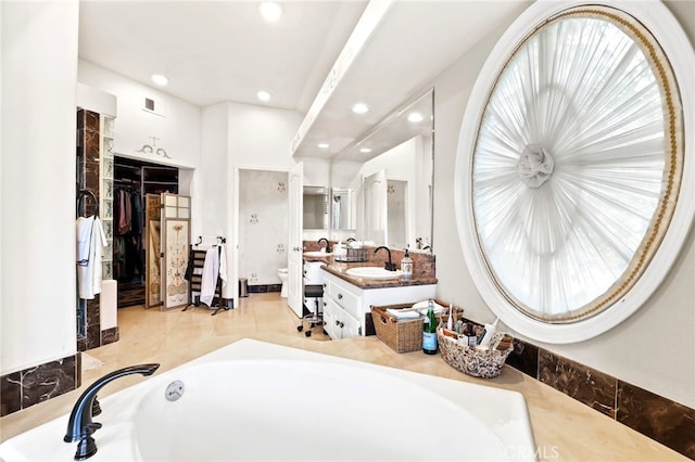 bathroom with vanity, tile patterned flooring, and toilet