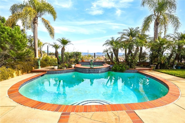 view of swimming pool with an in ground hot tub and a patio