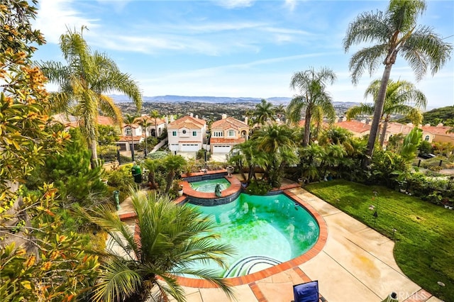 view of pool featuring an in ground hot tub