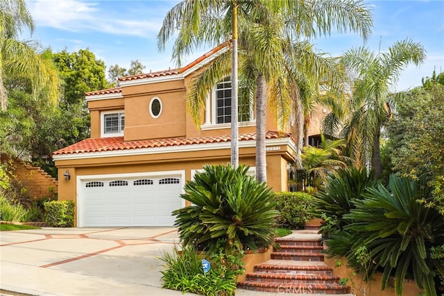 mediterranean / spanish-style house with a garage