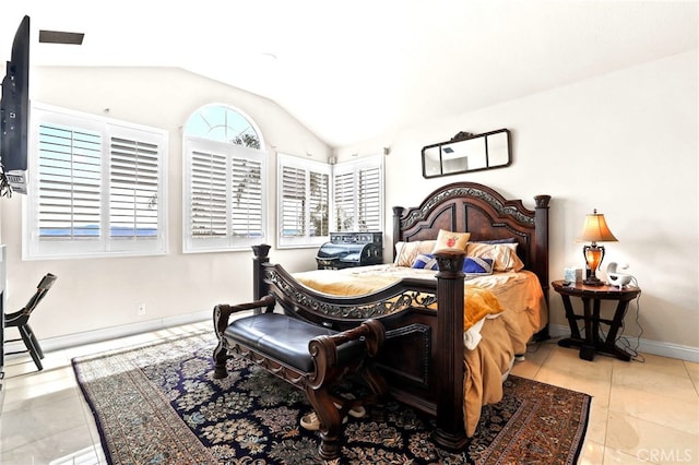 bedroom featuring vaulted ceiling and light tile patterned floors