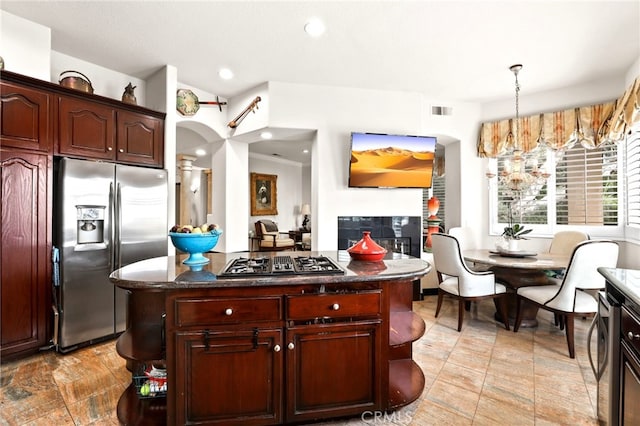 kitchen with pendant lighting, stainless steel appliances, and a kitchen island