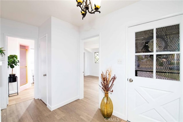 interior space with a chandelier and light hardwood / wood-style floors