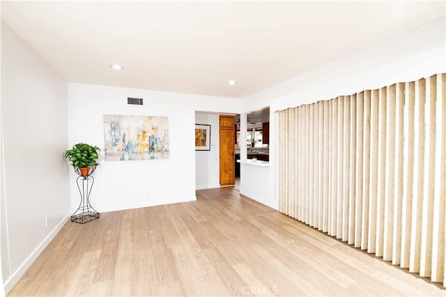 spare room featuring light hardwood / wood-style floors