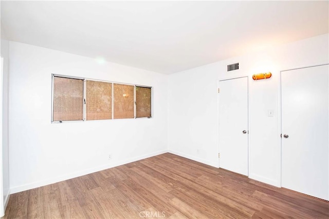 unfurnished bedroom featuring a closet and light hardwood / wood-style flooring