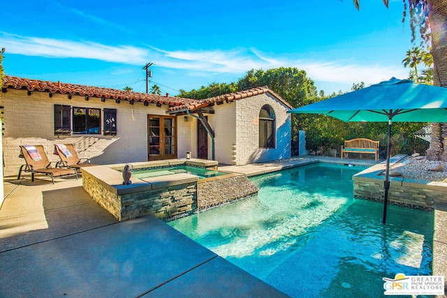 view of pool featuring an in ground hot tub and a patio area