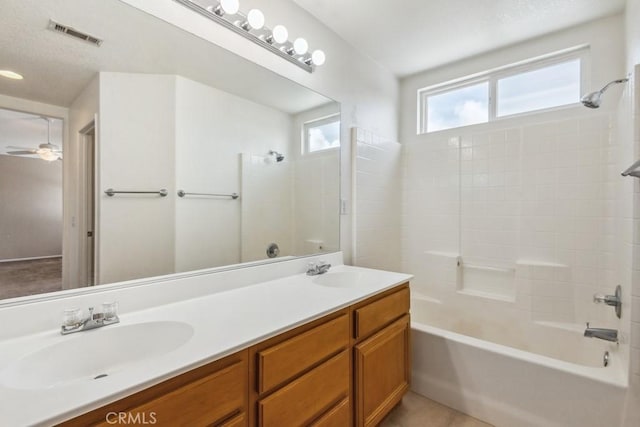 bathroom featuring vanity, tile patterned floors, ceiling fan, and washtub / shower combination