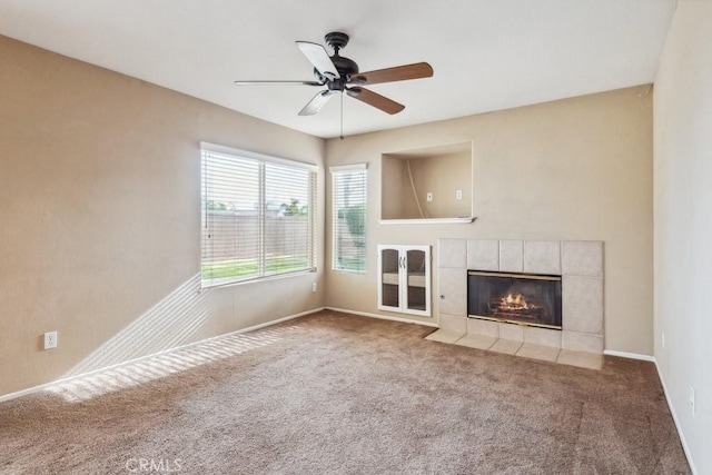 unfurnished living room with carpet floors, a fireplace, and ceiling fan