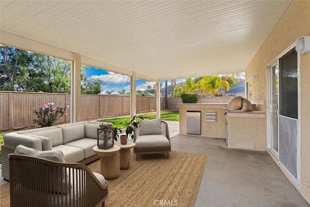 view of patio / terrace featuring area for grilling, an outdoor living space, and exterior kitchen