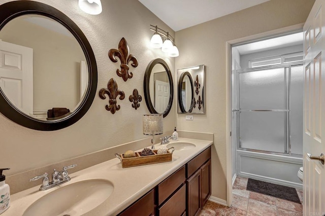 full bathroom with vanity, toilet, and shower / bath combination with glass door