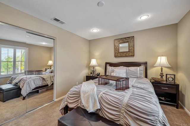 bedroom featuring light colored carpet and a closet