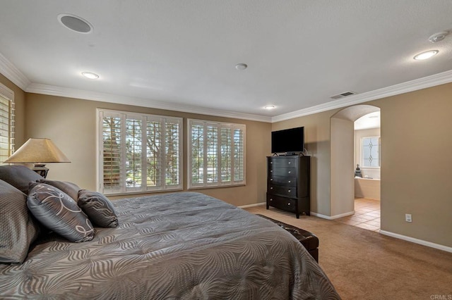 bedroom with connected bathroom, light colored carpet, and ornamental molding