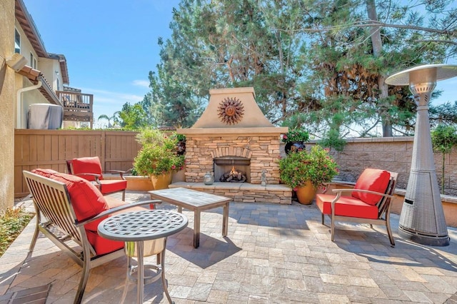 view of patio featuring an outdoor stone fireplace