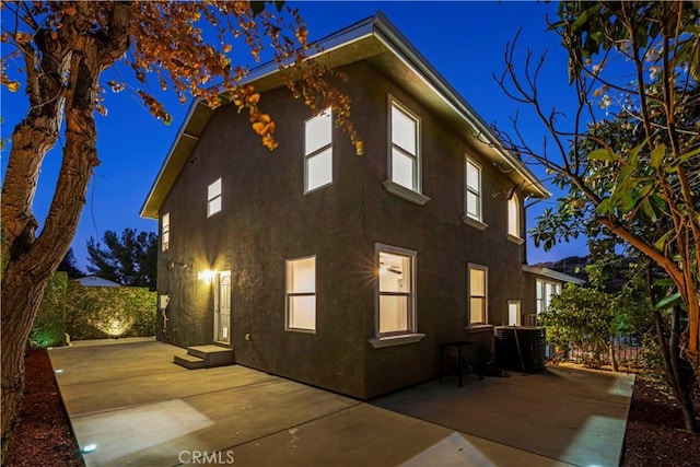 rear view of house with a patio area and cooling unit