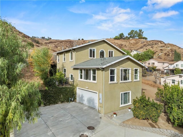 exterior space with a mountain view and a garage