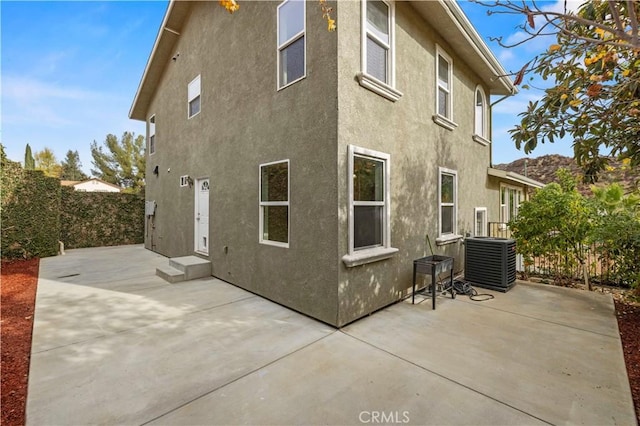 back of property featuring central air condition unit and a patio area