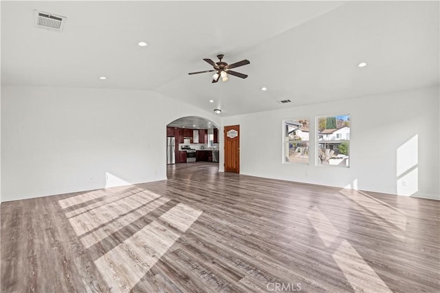 unfurnished living room with wood-type flooring, ceiling fan, and vaulted ceiling