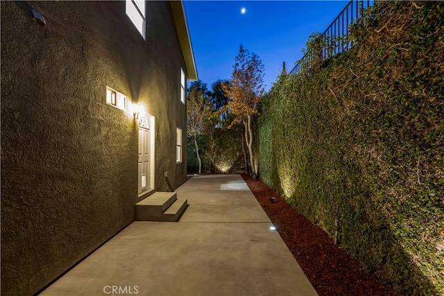 view of side of property featuring a patio area