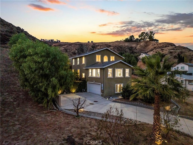 view of front property featuring a garage and a mountain view