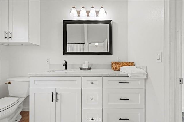 bathroom with vanity and toilet