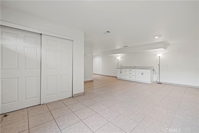 unfurnished living room with light tile patterned floors