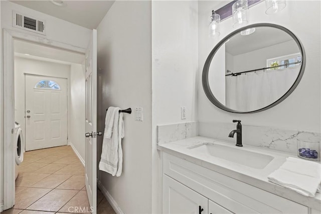 bathroom with tile patterned floors and vanity