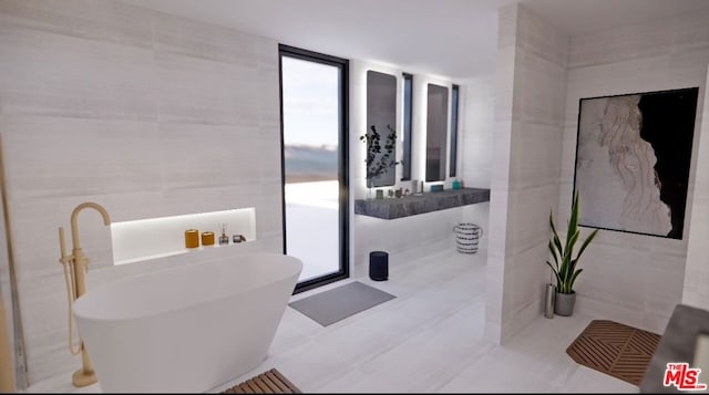 bathroom featuring tile walls, tile patterned flooring, a bathtub, and expansive windows