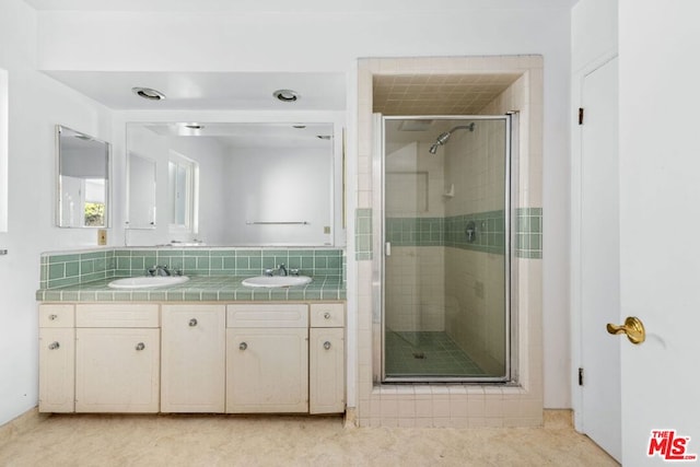 bathroom with tasteful backsplash, vanity, and walk in shower