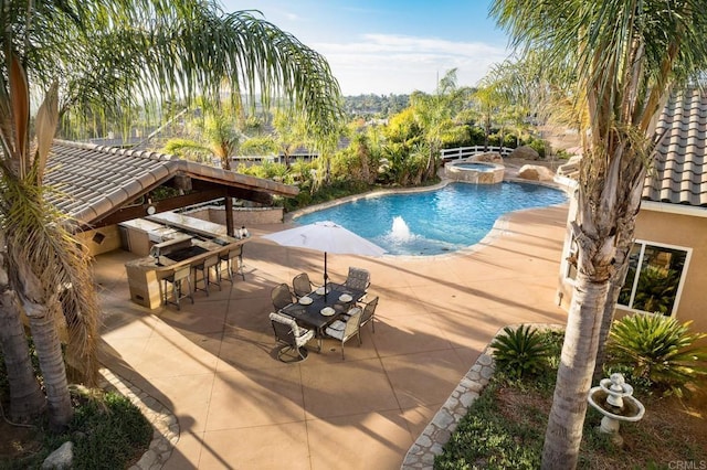 view of swimming pool featuring an in ground hot tub, a patio area, and exterior bar