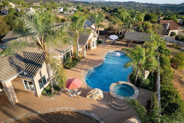 view of swimming pool featuring an in ground hot tub and a patio