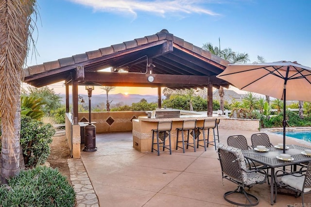 patio terrace at dusk with a gazebo and exterior bar