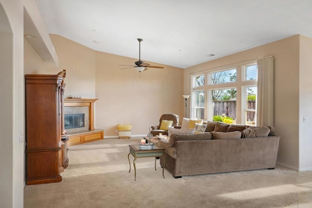 carpeted living room with vaulted ceiling and ceiling fan