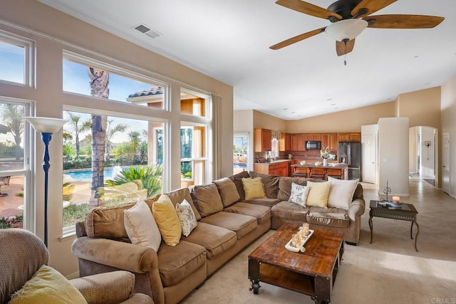 living room featuring ceiling fan and light colored carpet