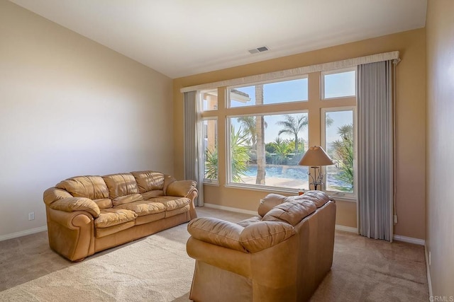 carpeted living room featuring a water view and vaulted ceiling