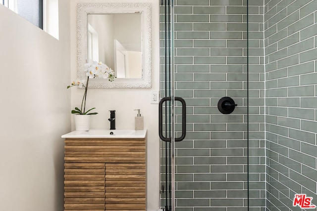 bathroom featuring vanity and an enclosed shower