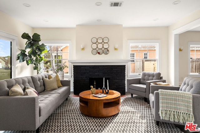 living room with a healthy amount of sunlight and a fireplace