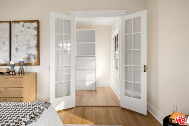 bedroom featuring french doors and hardwood / wood-style floors