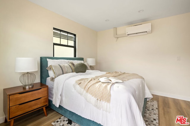 bedroom featuring a wall mounted air conditioner and dark hardwood / wood-style floors